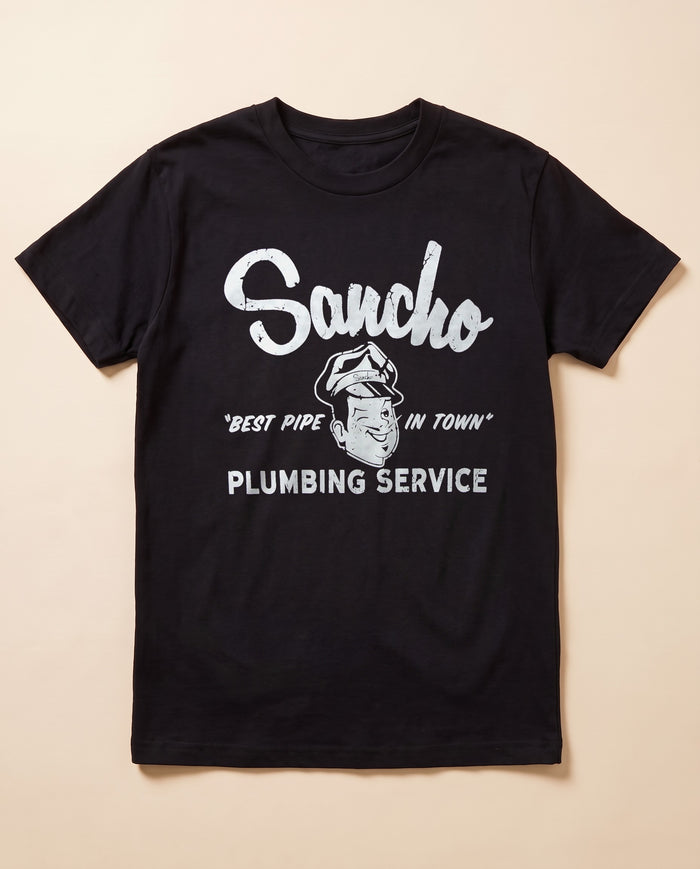Sancho Plumbing black tee — flat lay