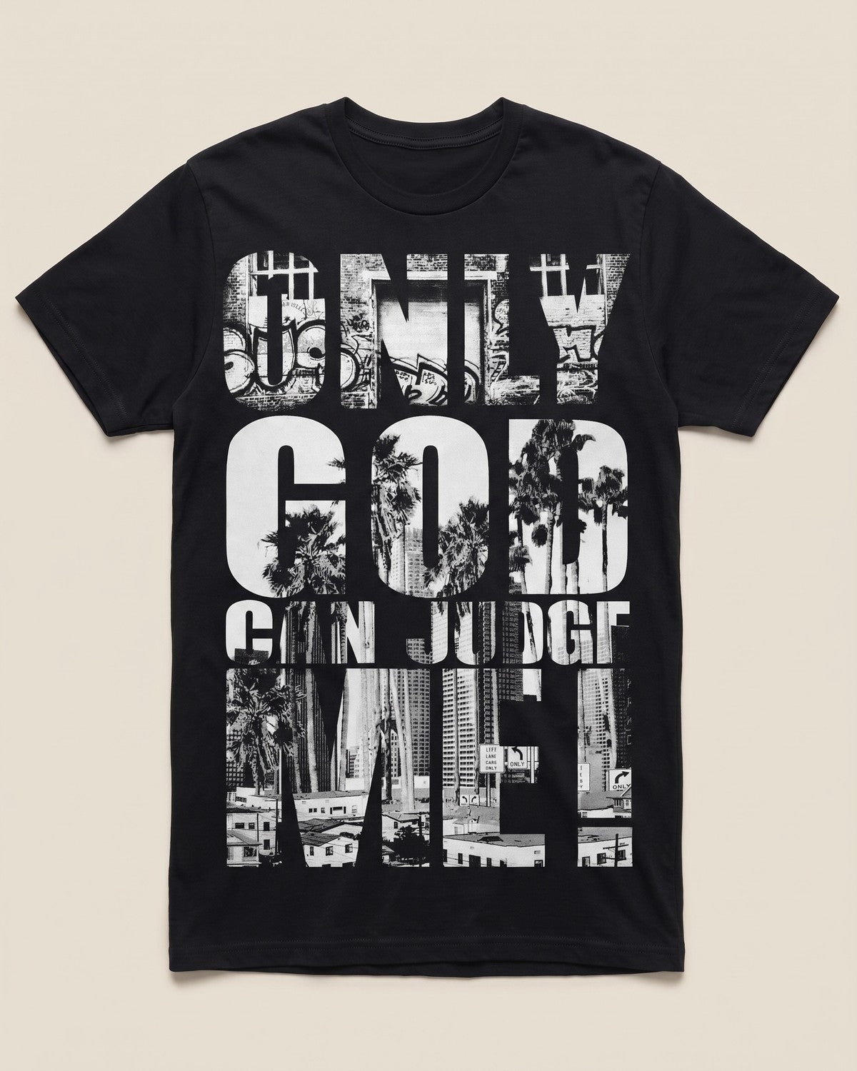 Only God Can Judge Me black tee, flat lay on bone background.